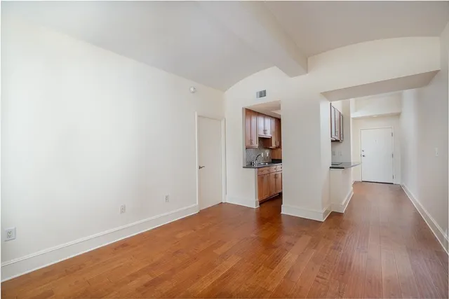 a view of a kitchen with wooden floor