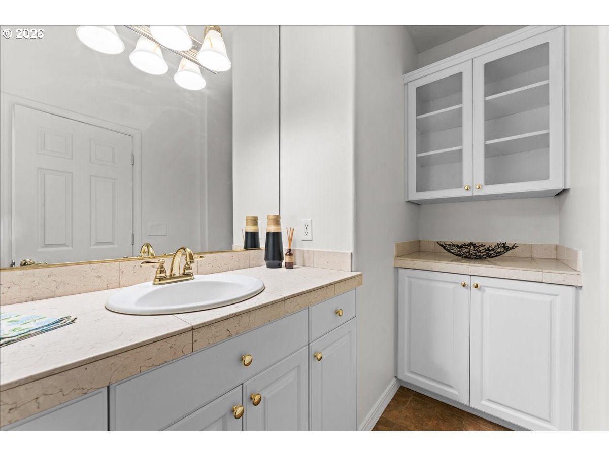 12431 Southwest 55th Place Portland, OR 97219 - Photo 11 of 40 a bathroom with a sink and a mirror