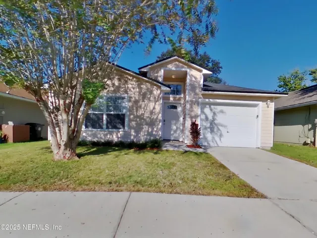 a view of a house with a yard