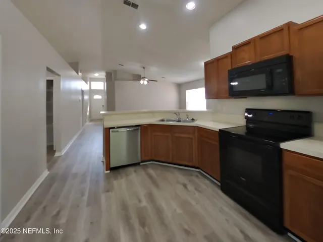 a kitchen with stainless steel appliances granite countertop a sink and cabinets