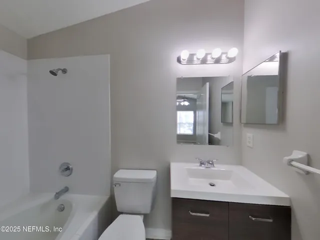 a bathroom with a sink toilet a mirror and shower