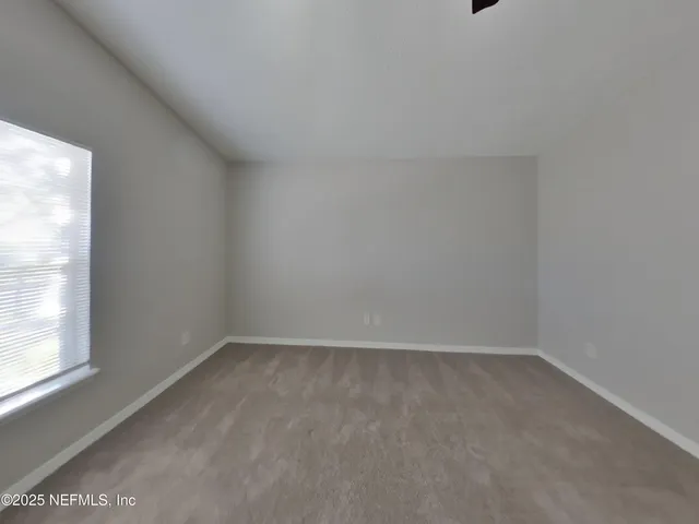 a view of an empty room and a window