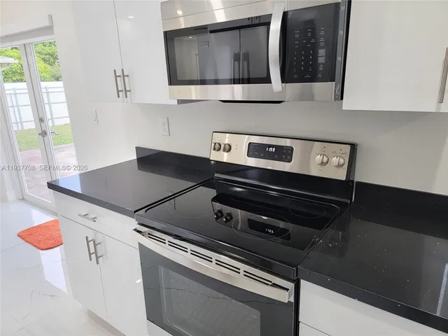 a kitchen with a stove and a microwave