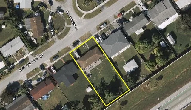 an aerial view of multiple houses with yard