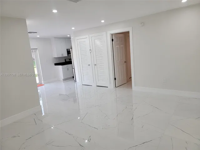 a view of kitchen with refrigerator and white floor
