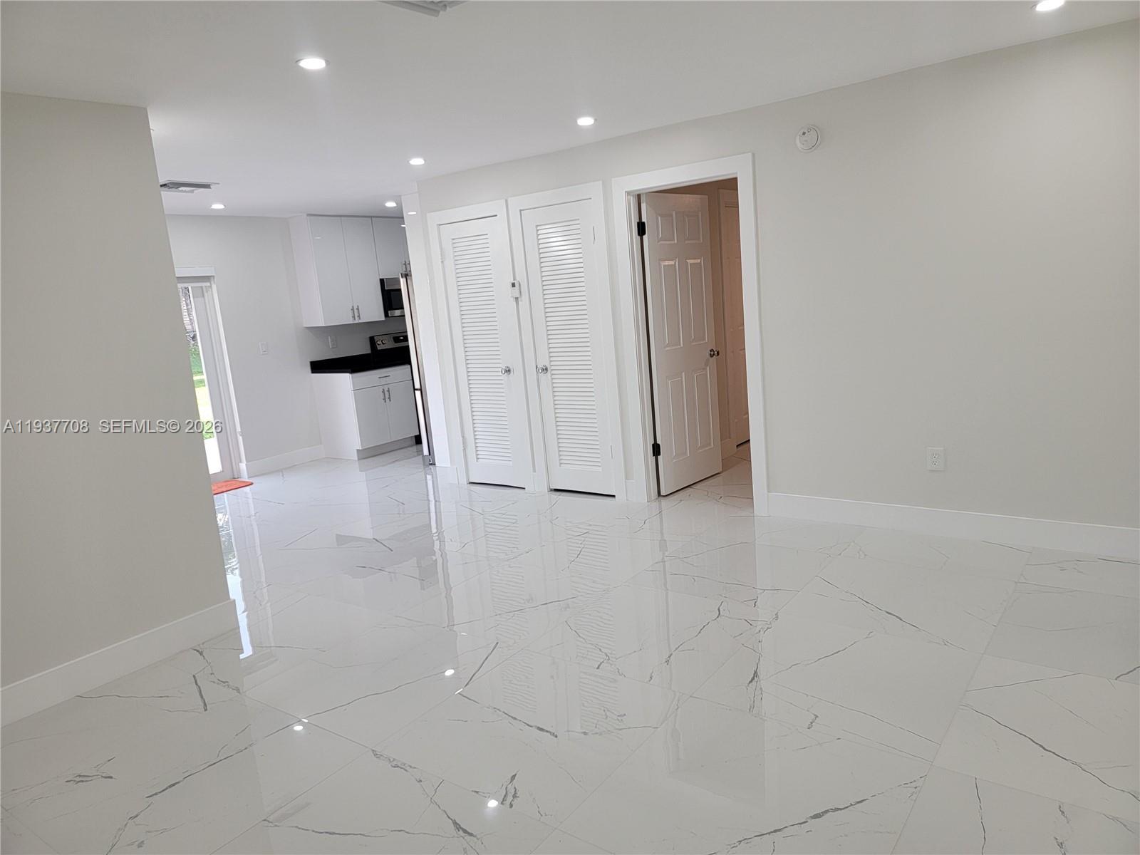 14860 Southwest 307th Street Homestead, FL 33033 - Photo 6 of 14 a view of kitchen with refrigerator and white floor