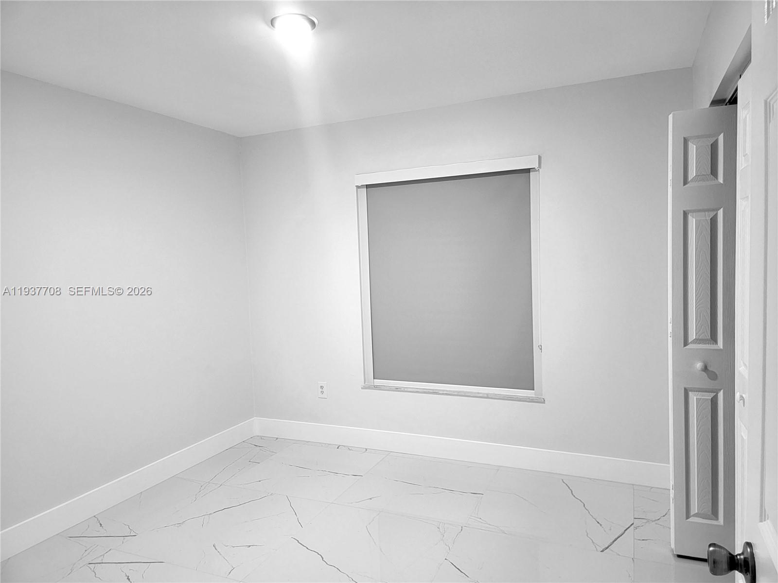 14860 Southwest 307th Street Homestead, FL 33033 - Photo 8 of 14 an empty room with a window