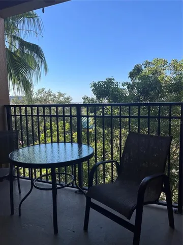 a view of a balcony with furniture