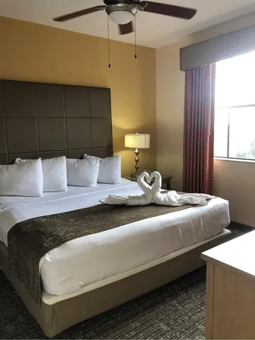 a bedroom with bed and window