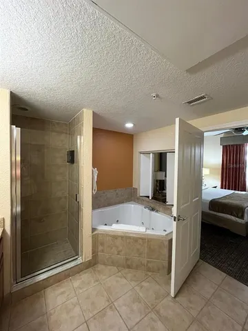 a large spacious bathroom with a tub and shower