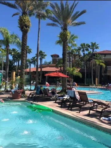 a front view of a house with garden and sitting area