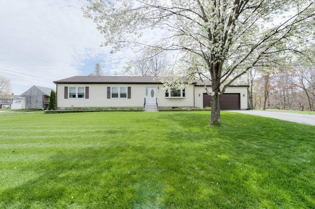 23 Riverside Street Three Rivers, MA 01080 - Photo 1 of 33 a house that is sitting in middle of the grass