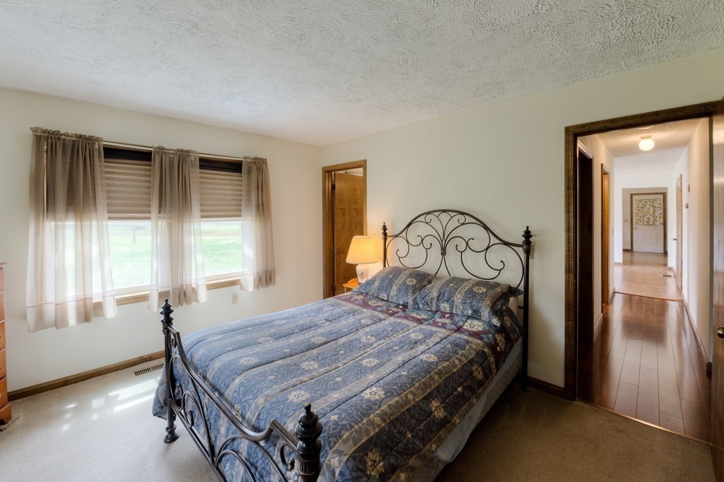 23 Riverside Street Three Rivers, MA 01080 - Photo 15 of 33 a bedroom with a bed next to a window with outer view