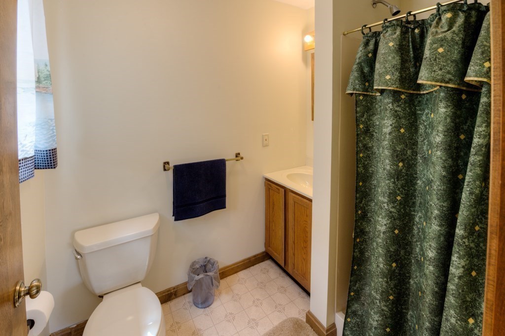 23 Riverside Street Three Rivers, MA 01080 - Photo 17 of 33 a bathroom with a toilet and a shower curtain