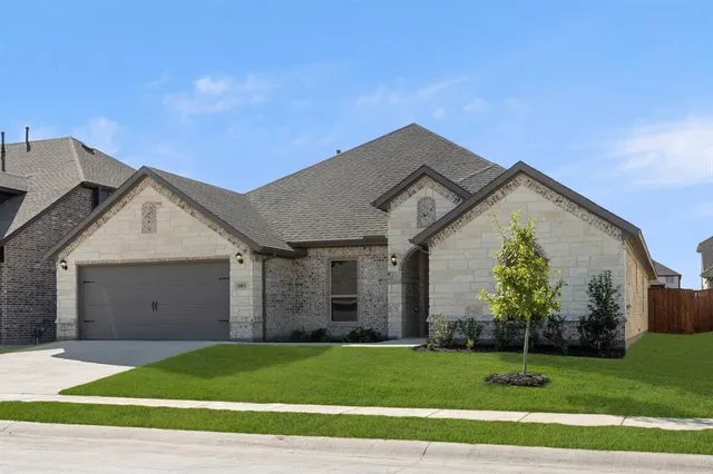 a view of a house with a yard and garage