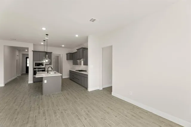 a kitchen with stainless steel appliances a refrigerator and a stove top oven
