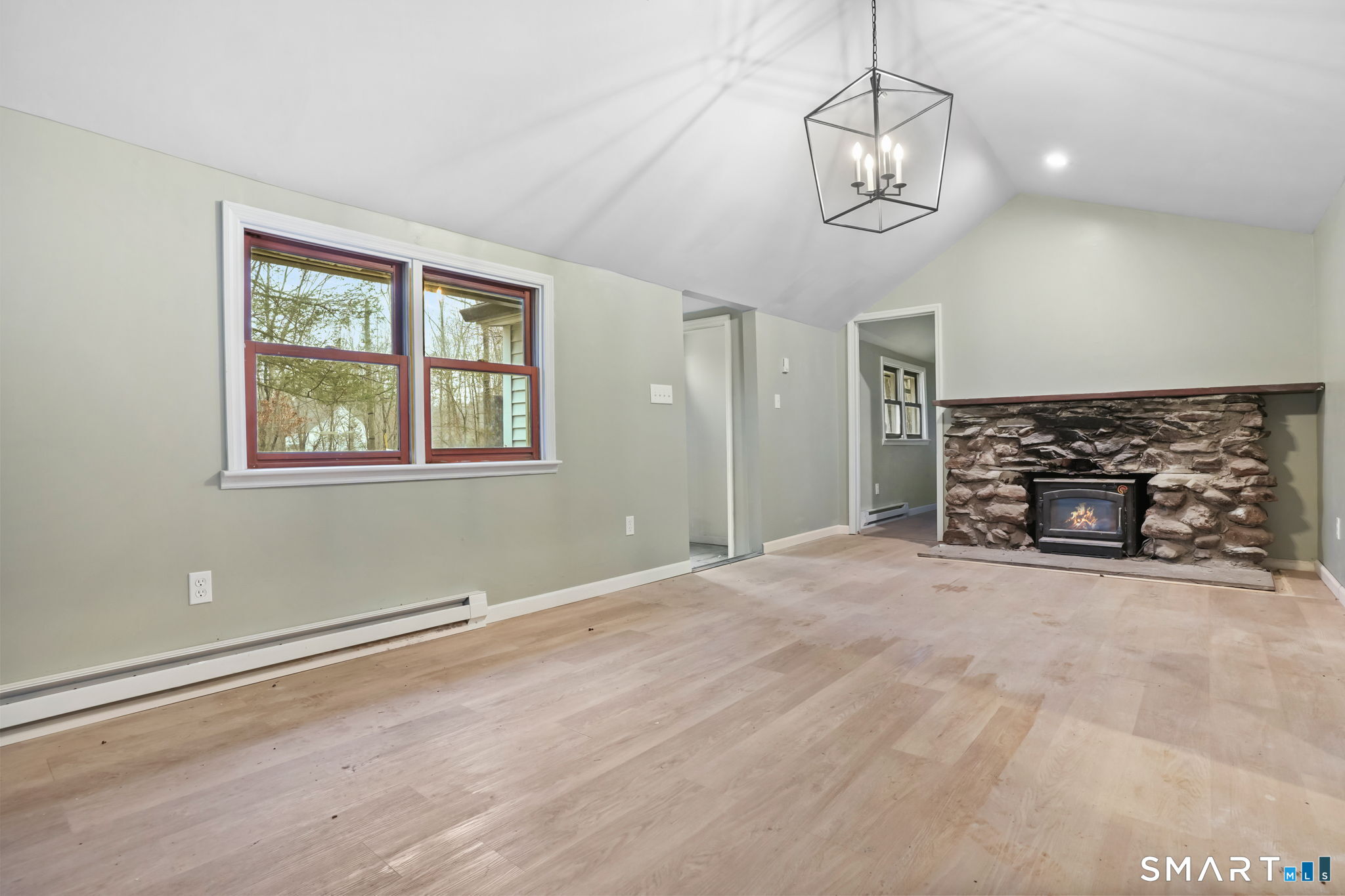 71 Picketts Ridge Road Redding, CT 06896 - Photo 11 of 32 a view of empty room with wooden floor and kitchen