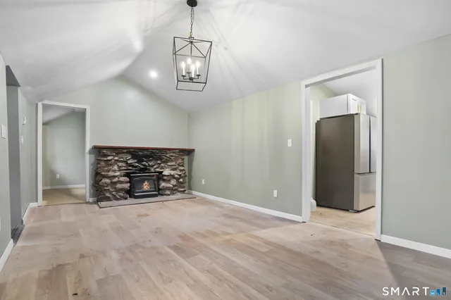 an empty room with windows and ceiling fan
