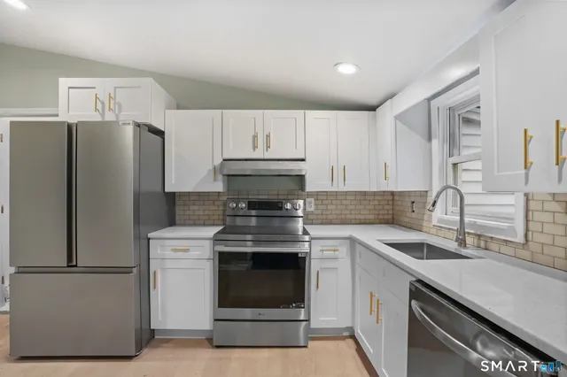a kitchen with a stove sink and refrigerator