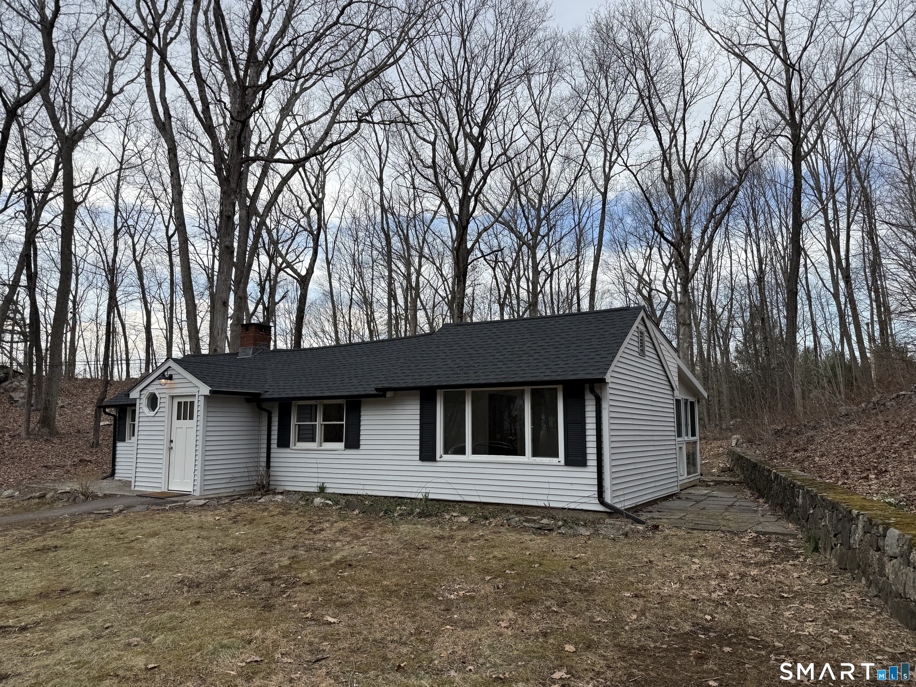 71 Picketts Ridge Road Redding, CT 06896 - Photo 2 of 32 a front view of a house with a garden