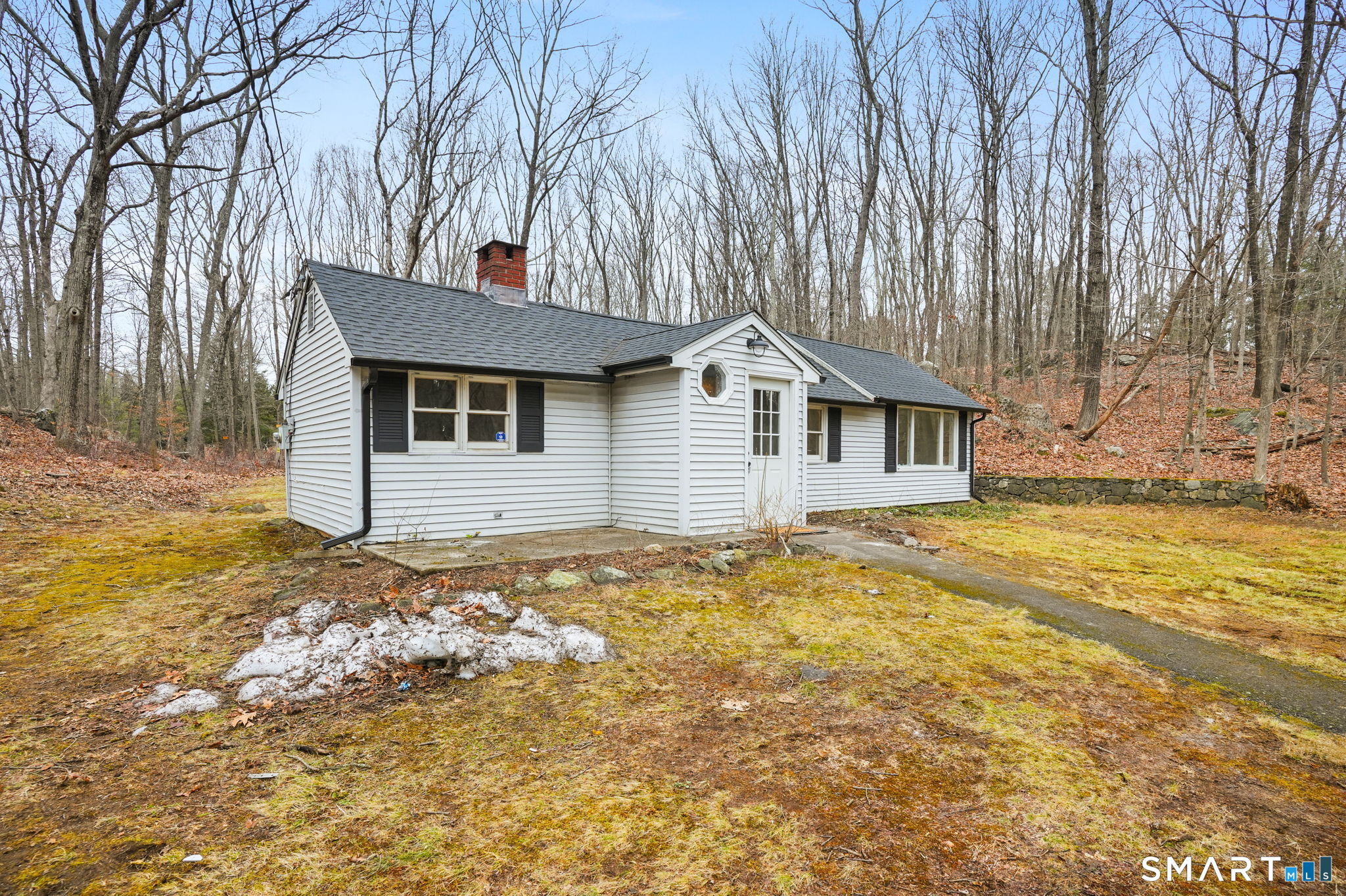 71 Picketts Ridge Road Redding, CT 06896 - Photo 26 of 32 a front view of a house with a garden