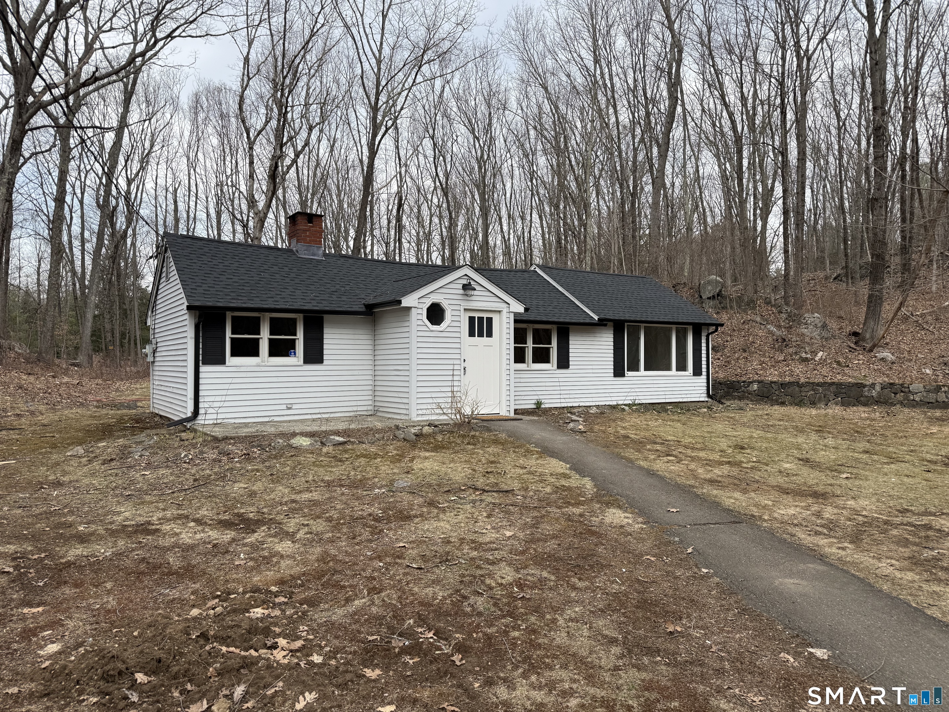 71 Picketts Ridge Road Redding, CT 06896 - Photo 28 of 32 a front view of a house with a garden