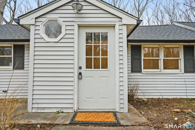 a front view of a house with large windows