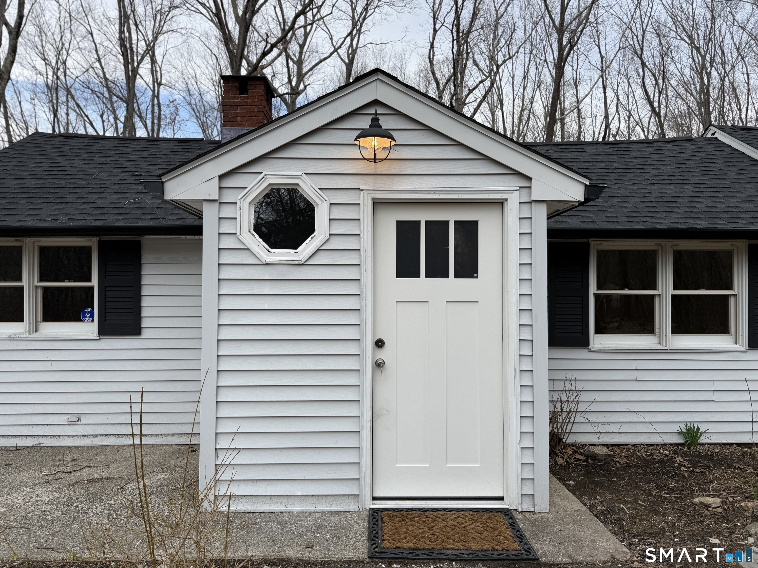 71 Picketts Ridge Road Redding, CT 06896 - Photo 8 of 32 a view of a house with a door and a yard