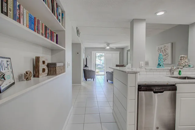 a kitchen with stainless steel appliances granite countertop a sink and white cabinets