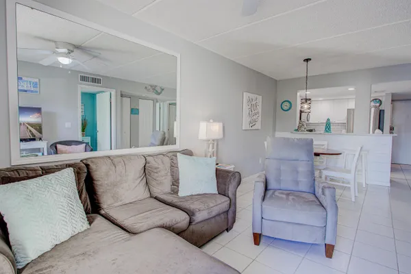 a bedroom with a bed and a lamp on the dresser