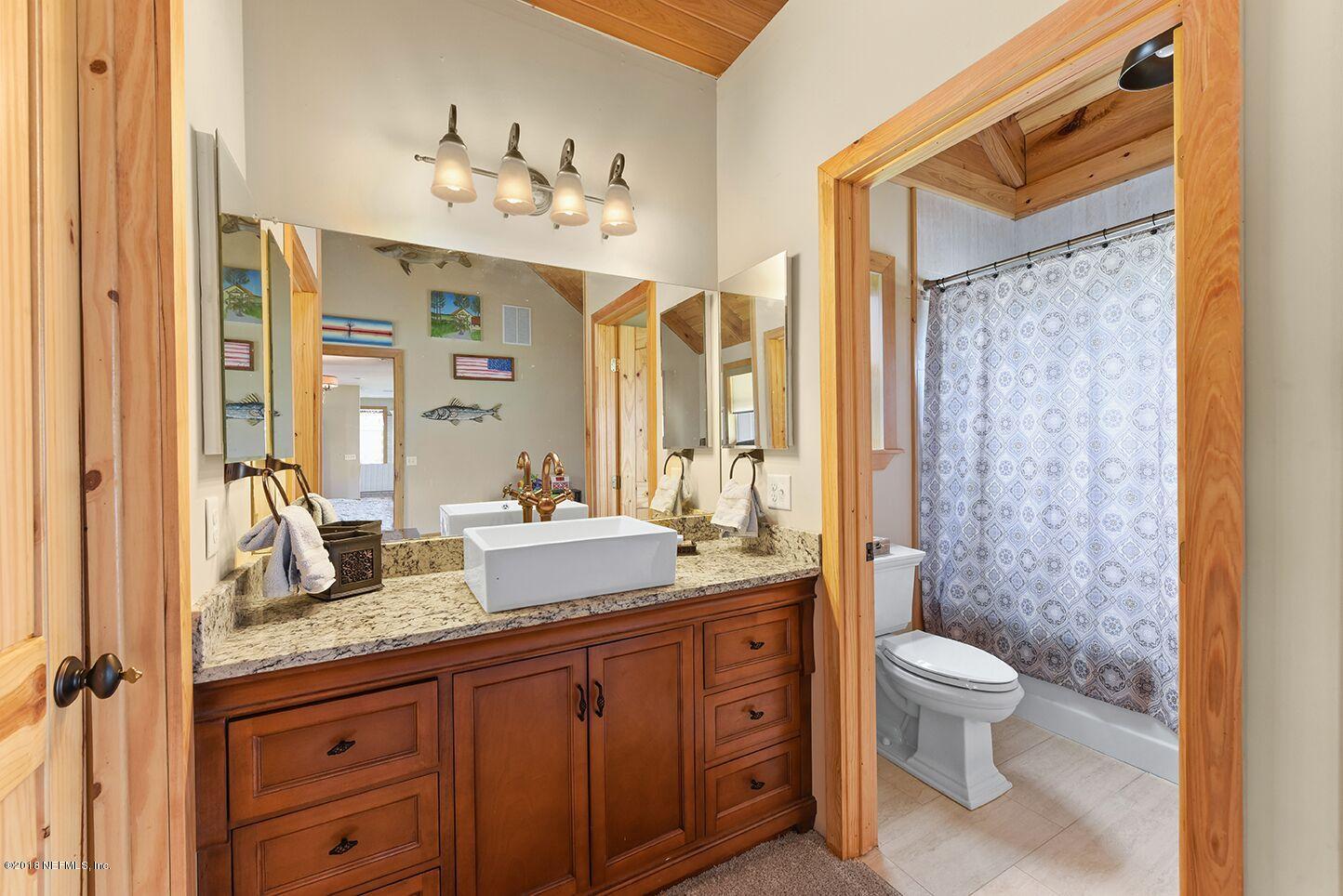 12715 Sawpit Road Jacksonville, FL 32226 - Photo 12 of 35 a spacious bathroom with a granite countertop sink toilet mirror and shower