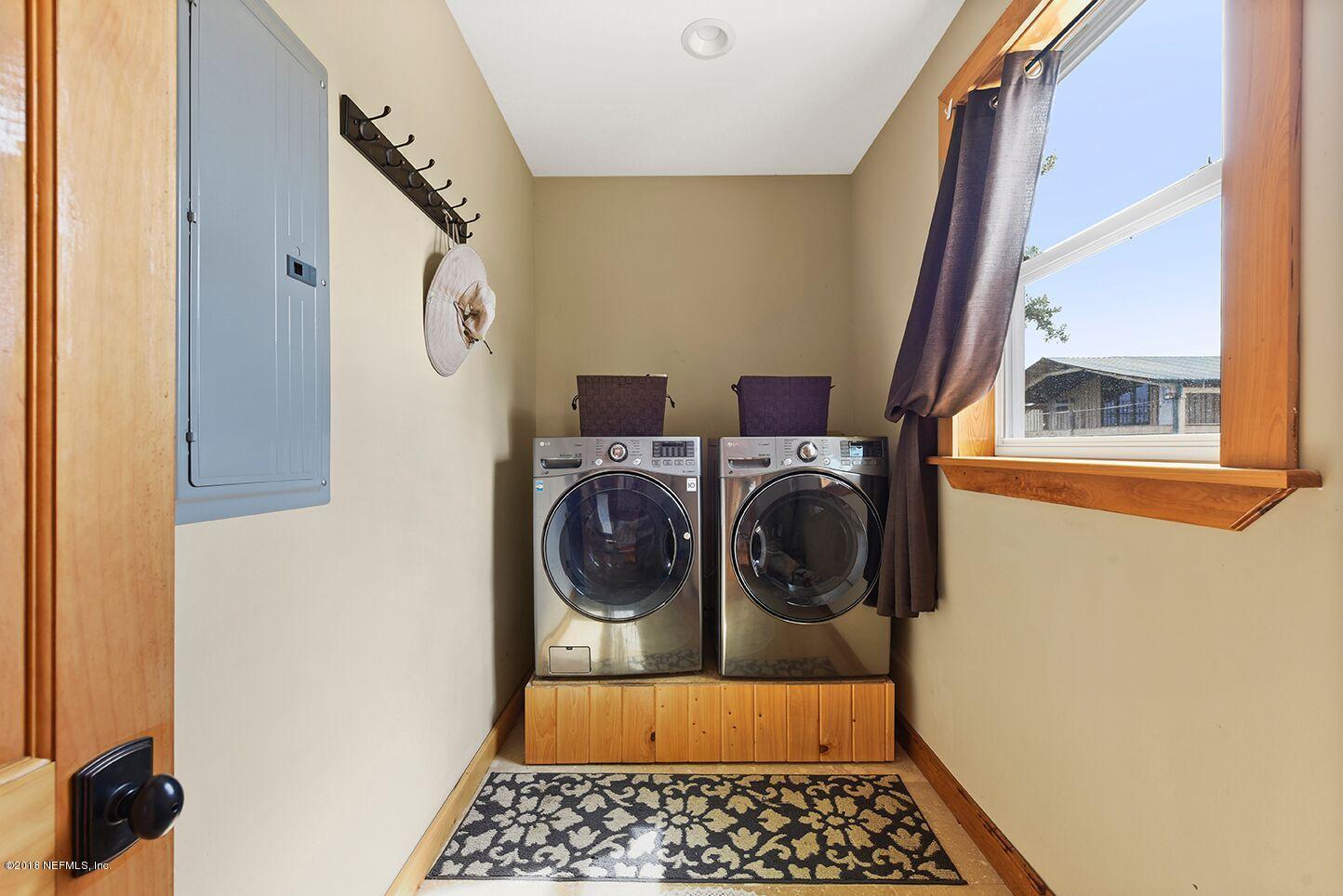 12715 Sawpit Road Jacksonville, FL 32226 - Photo 13 of 35 a bathroom with a sink a washer and dryer