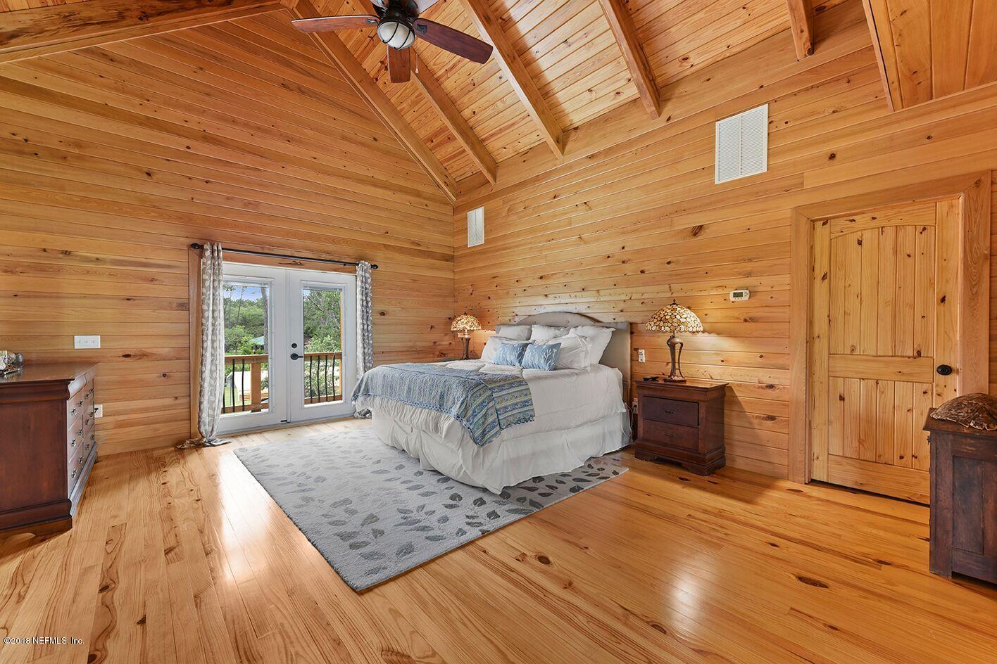 12715 Sawpit Road Jacksonville, FL 32226 - Photo 16 of 35 a bedroom with a bed and wooden floor