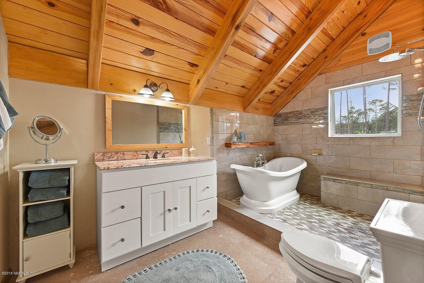 12715 Sawpit Road Jacksonville, FL 32226 - Photo 17 of 35 a bathroom with a granite countertop sink a toilet and a mirror