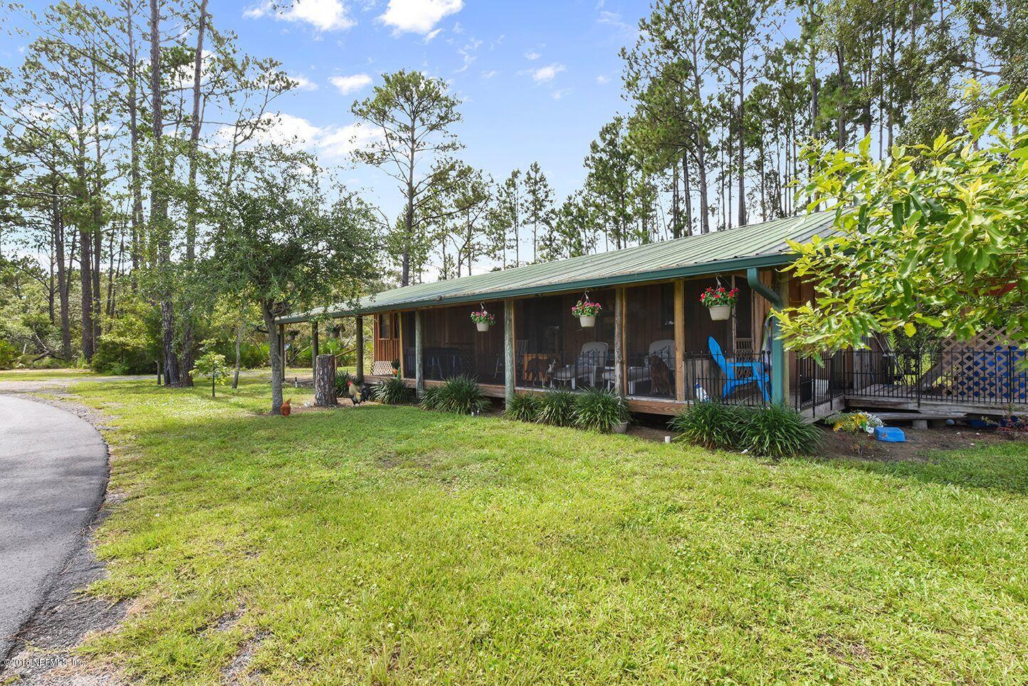 12715 Sawpit Road Jacksonville, FL 32226 - Photo 23 of 35 a view of a house with a yard porch and sitting area