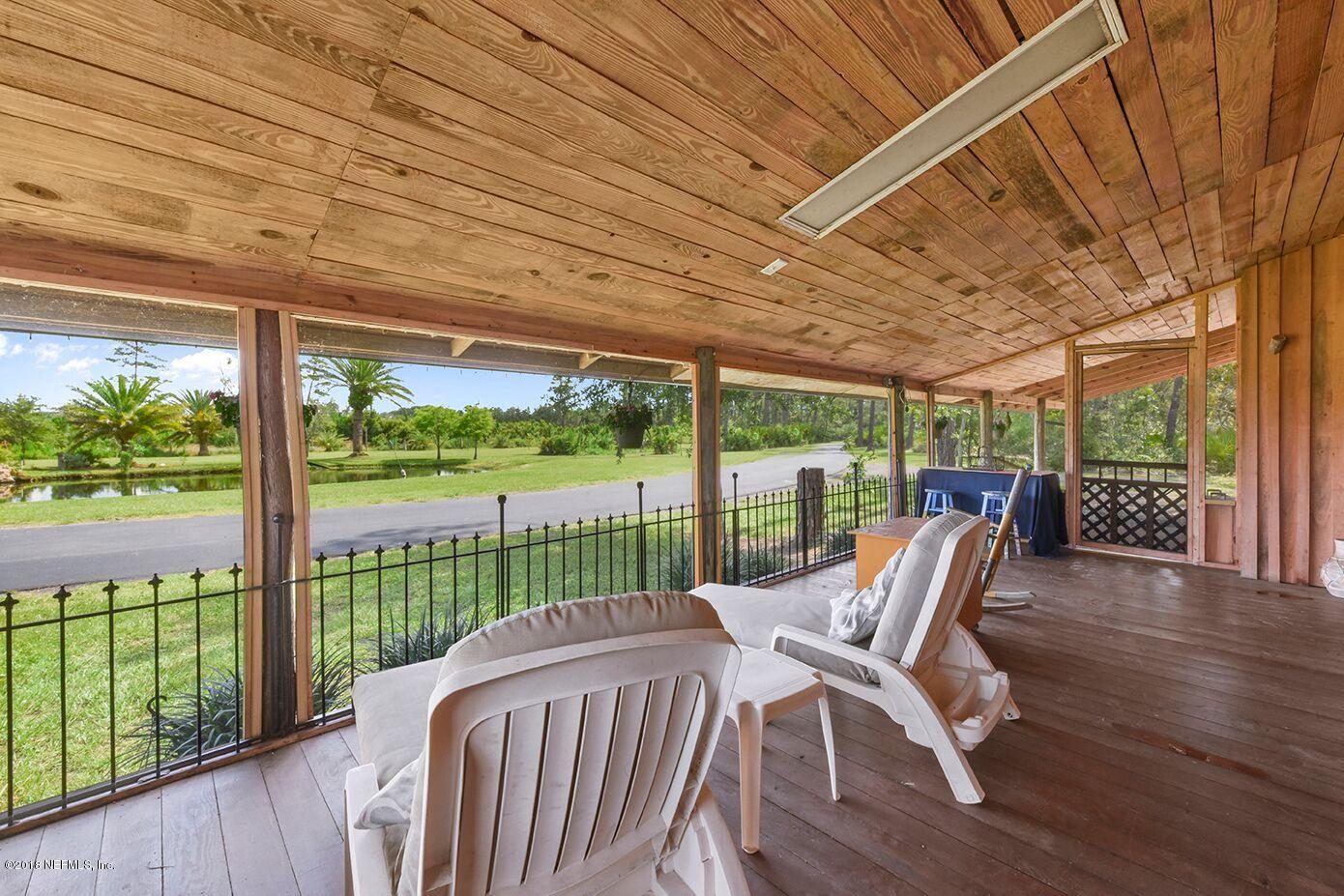 12715 Sawpit Road Jacksonville, FL 32226 - Photo 25 of 35 a view of a patio with a table chairs and a backyard