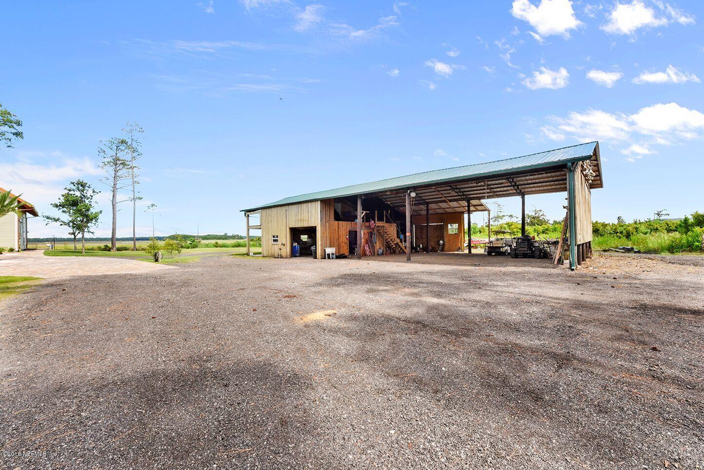 12715 Sawpit Road Jacksonville, FL 32226 - Photo 29 of 35 a view of a house with a yard and potted plants
