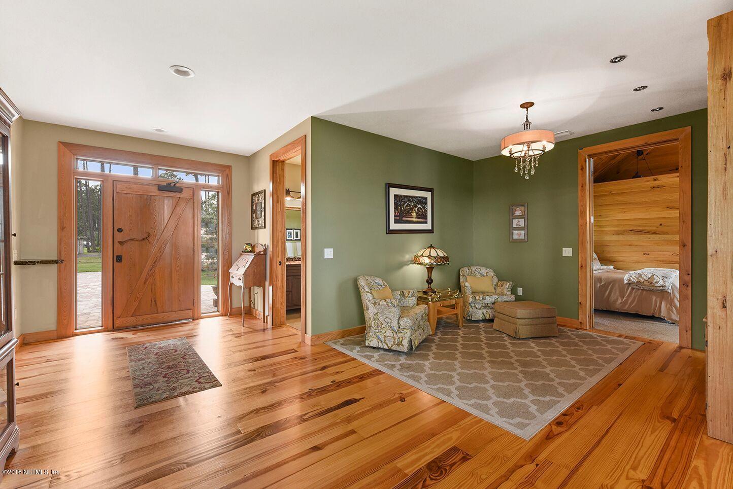 12715 Sawpit Road Jacksonville, FL 32226 - Photo 3 of 35 a living room with furniture and a chandelier