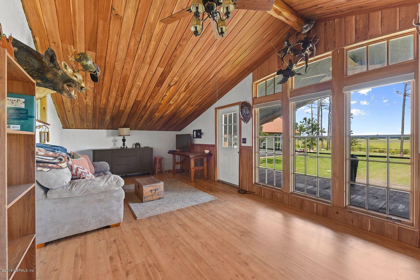 12715 Sawpit Road Jacksonville, FL 32226 - Photo 32 of 35 a living room with furniture a large window with outer view