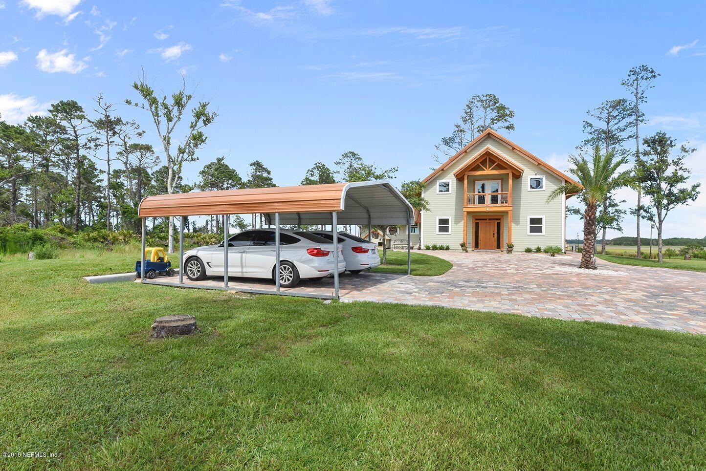 12715 Sawpit Road Jacksonville, FL 32226 - Photo 34 of 35 a view of a big house with a big yard and large trees