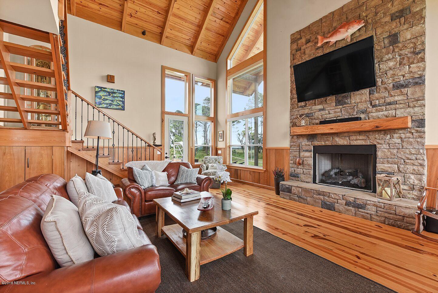 12715 Sawpit Road Jacksonville, FL 32226 - Photo 4 of 35 a living room with furniture a flat screen tv and a fireplace