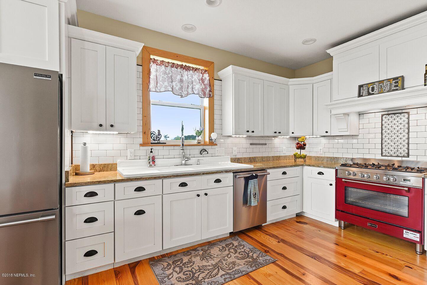 12715 Sawpit Road Jacksonville, FL 32226 - Photo 6 of 35 a kitchen with granite countertop white cabinets stainless steel appliances a sink and a window