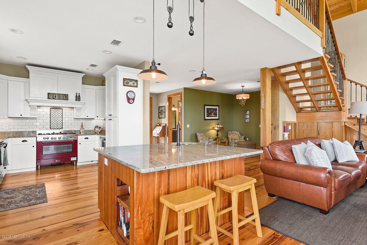 12715 Sawpit Road Jacksonville, FL 32226 - Photo 7 of 35 a living room with kitchen island granite countertop furniture and a fireplace