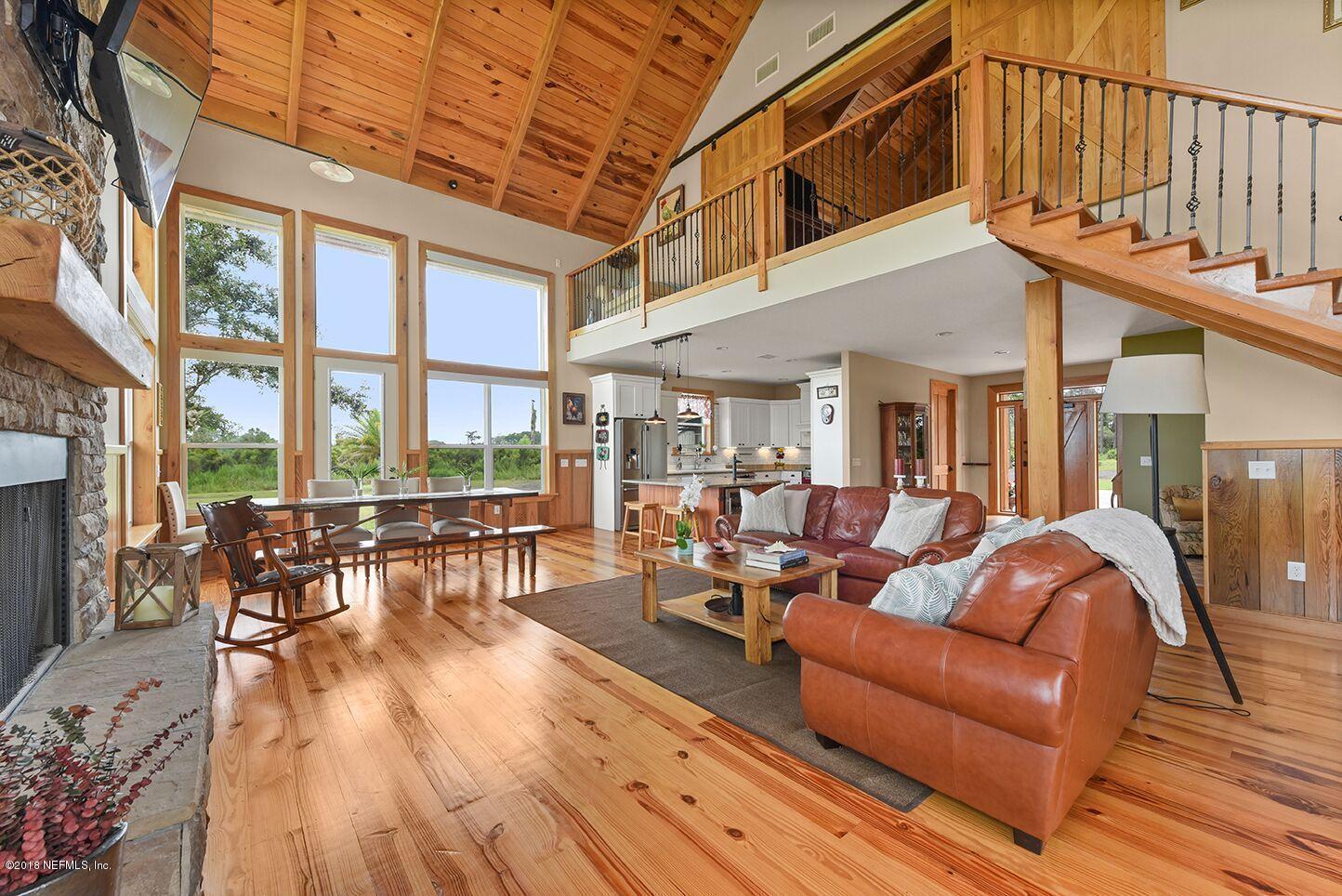 12715 Sawpit Road Jacksonville, FL 32226 - Photo 8 of 35 a view of a patio with couches table and chairs and wooden floor