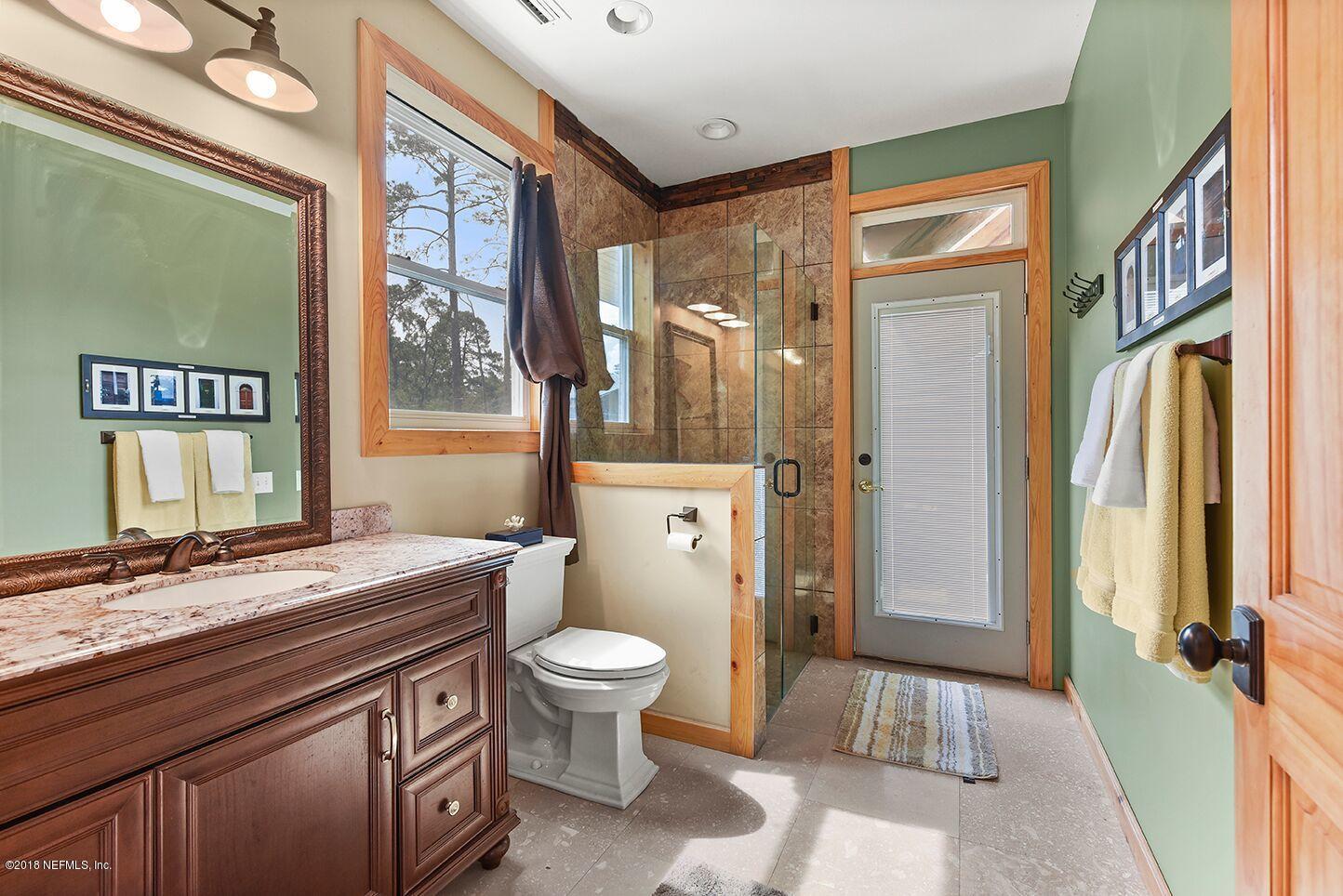 12715 Sawpit Road Jacksonville, FL 32226 - Photo 9 of 35 a spacious bathroom with a granite countertop sink toilet and shower