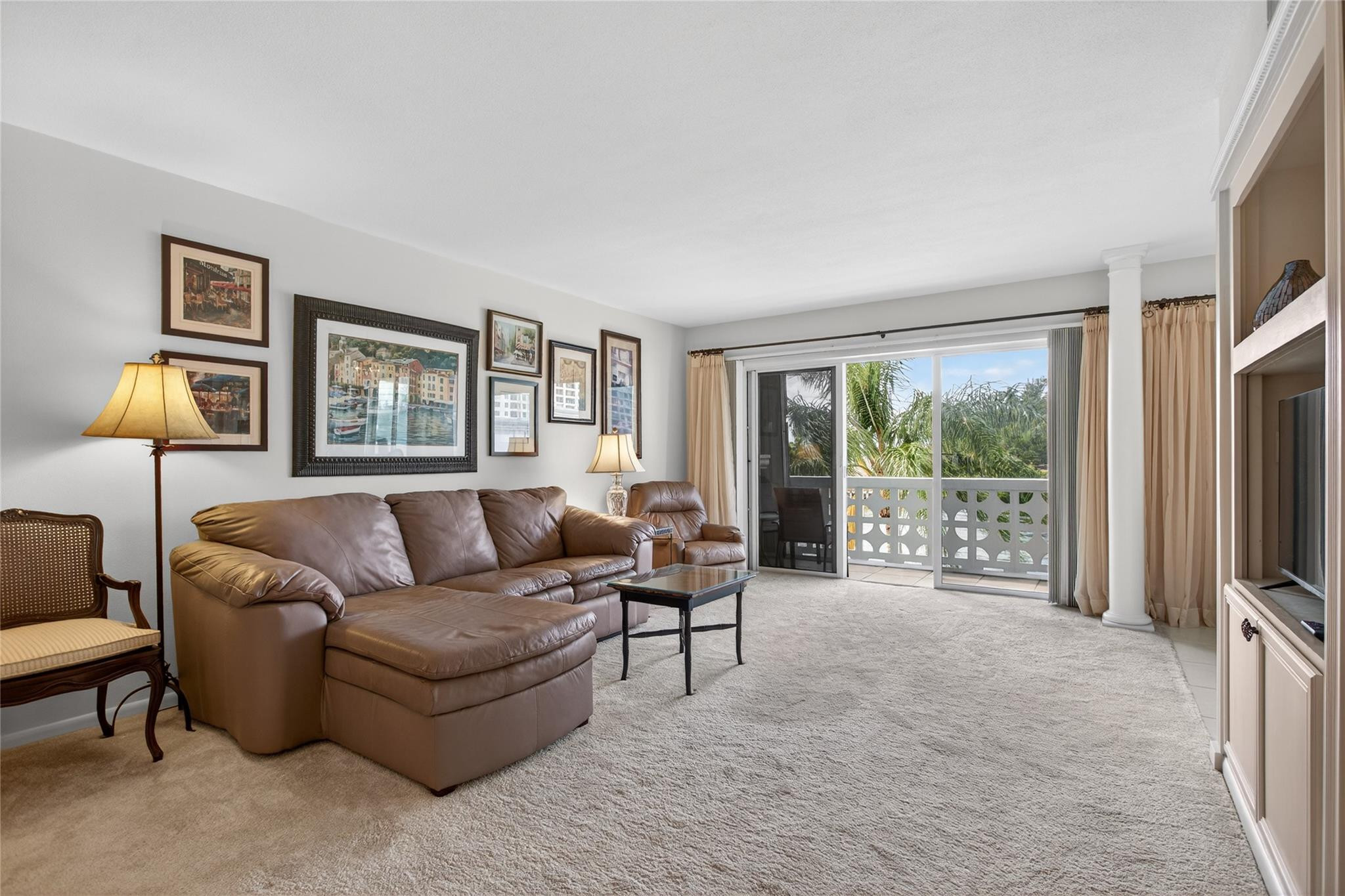 1001 North Riverside Drive, Unit 305 Pompano Beach, FL 33062 - Photo 11 of 44 a living room with furniture and a flat screen tv