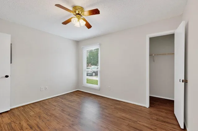 a bedroom with a bed and a potted plant
