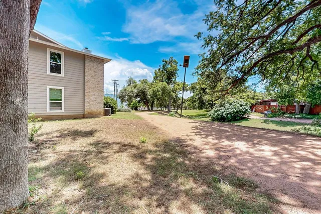 a view of a house with a small yard and plants
