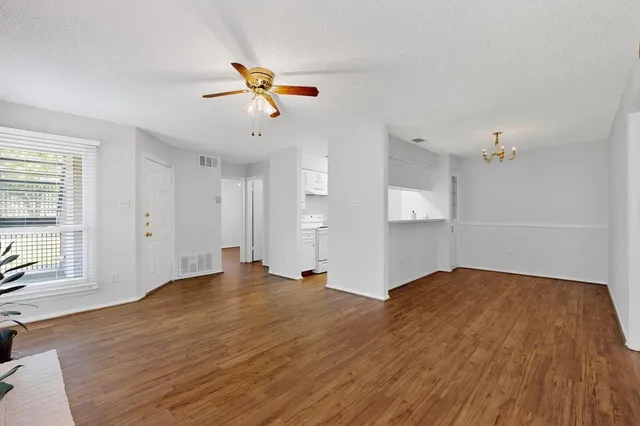 a view of a room with wooden floor and air conditioner