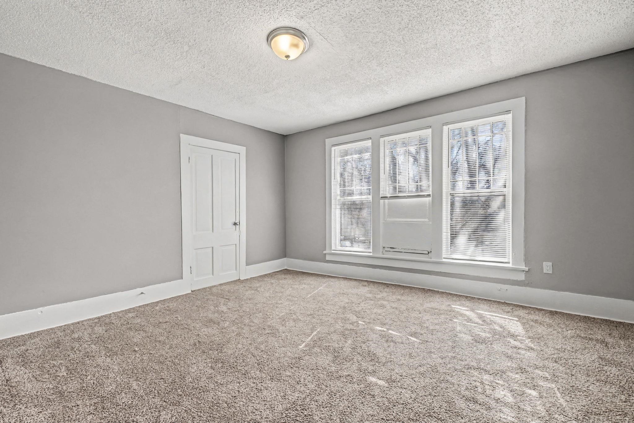 320 North High Street Covington, TN 38019 - Photo 19 of 32 an empty room with a empty space and windows